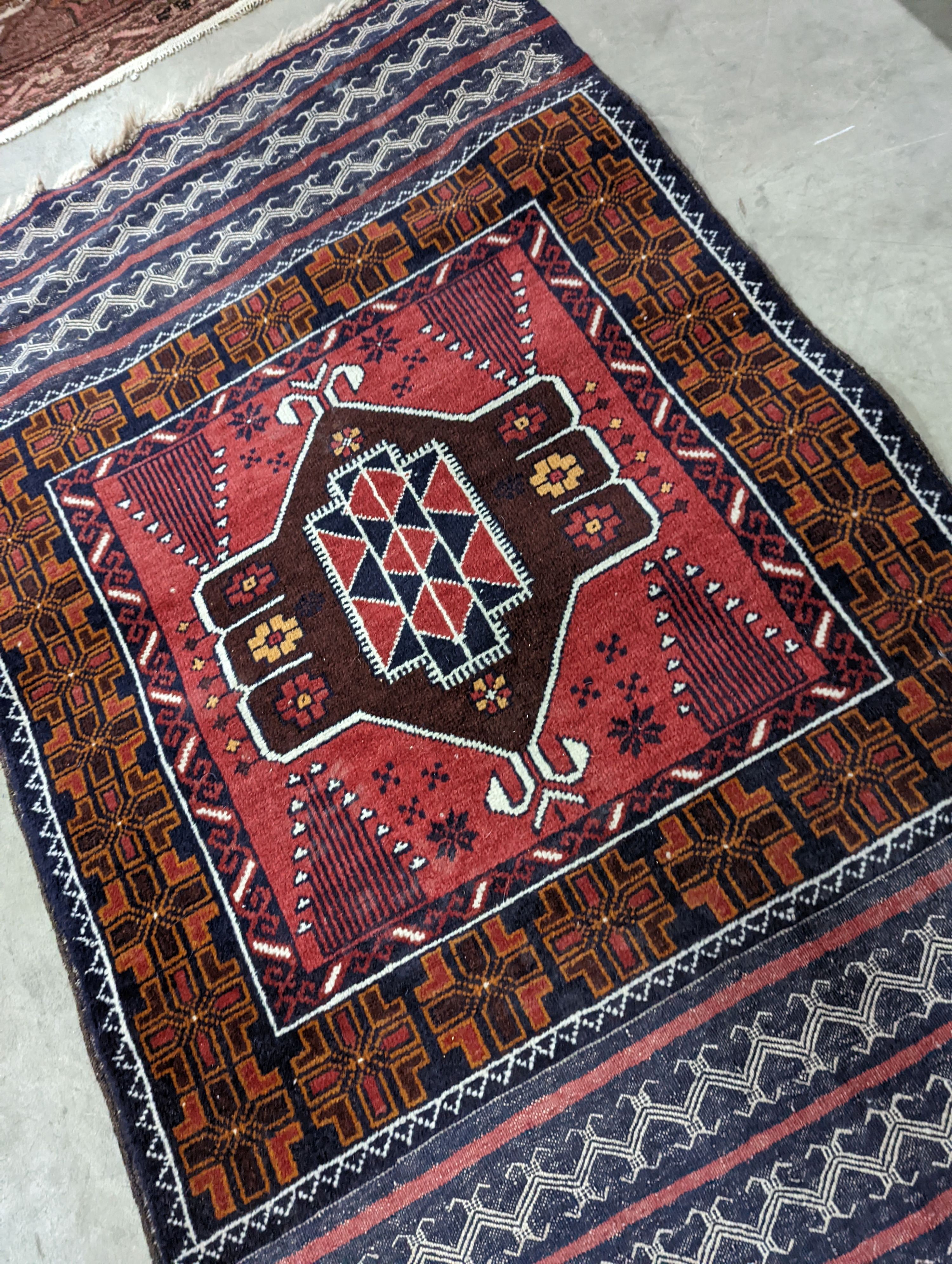 A Belouch geometric prayer rug and two Caucasian design rugs, largest 152 x 104cm